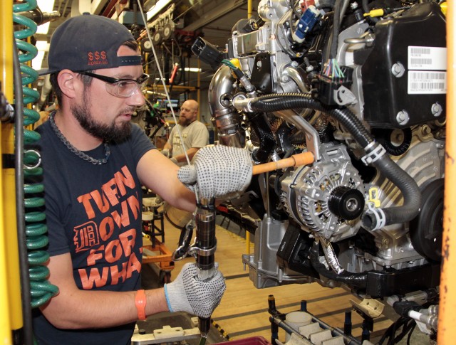 Jared Omell makes final touches to an EcoDiesel engine prior to installation at Warren Truck Assembly Plant