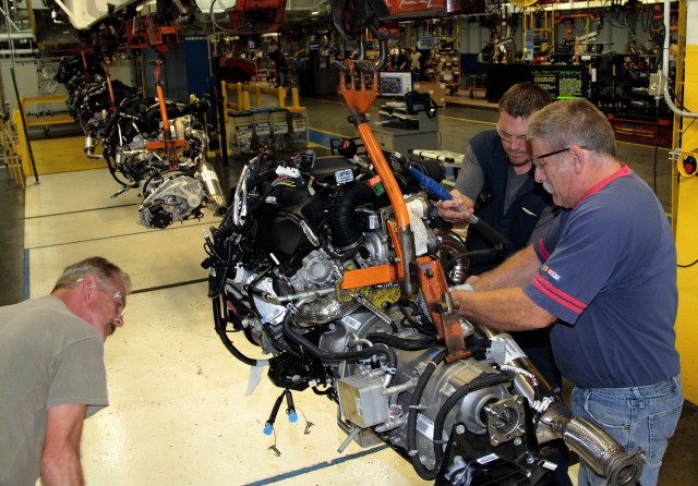 Mark Blake, Charles Vanatta and David Coutts inspect an EcoDiesel engine and 8-speed transmission prior to installation at Warren Truck Assembly Plant