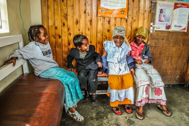 Kenyan kids wait to see the doctor, dressed in their sunday best.