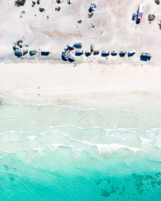 aerial views of baja beach with campervans