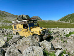 Man and Machine - Land Cruiser driving in a field of rocks