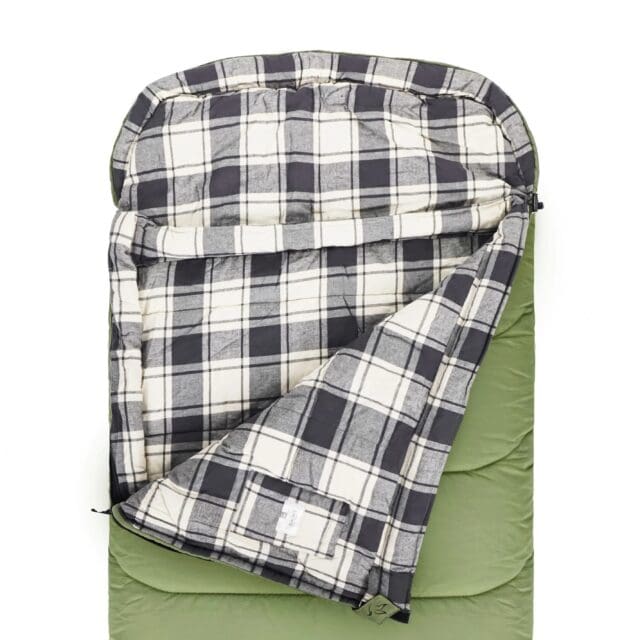 A green sleeping bag is partially unzipped, revealing a soft, plaid interior in black, white, and gray tones—perfect for your next Overland News-inspired adventure. The sleeping bag features a hooded top and a rectangular shape.