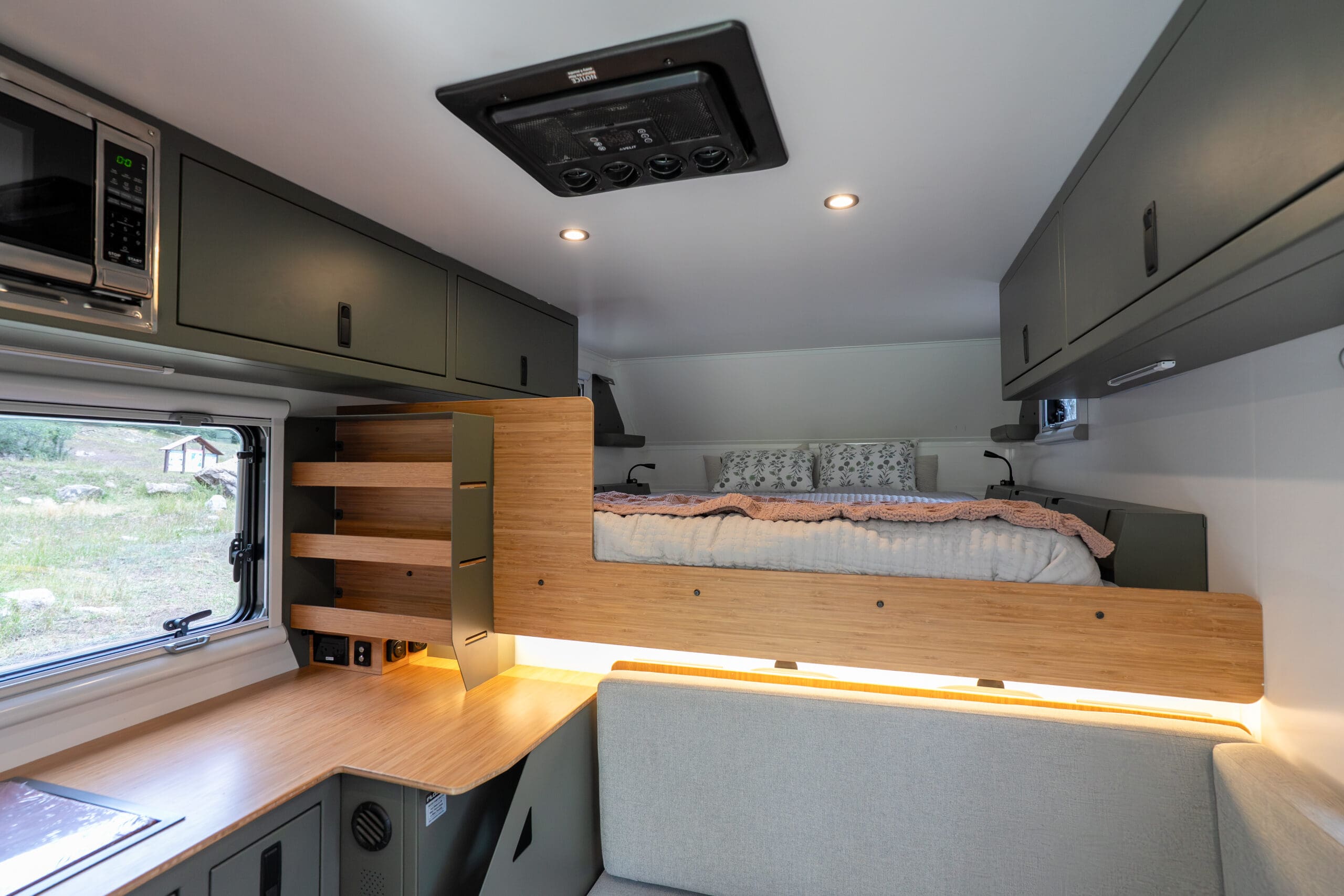 interior of truck camper with bed, windows, countertop