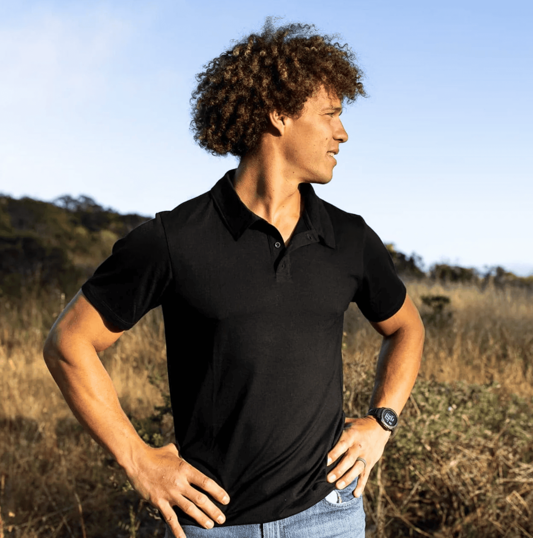 man in black t-shirt posing outdoors