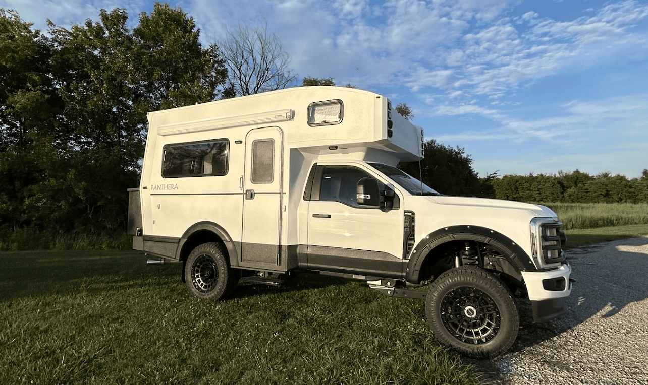 white truck and camper parked outdoors