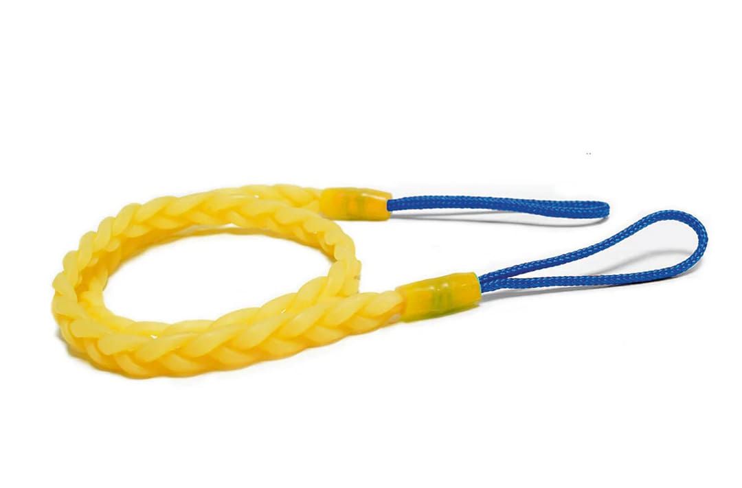 A yellow, braided, flexible loop with blue string handles on each end, designed as a handheld tool for camp laundry needs, is placed on a white background.