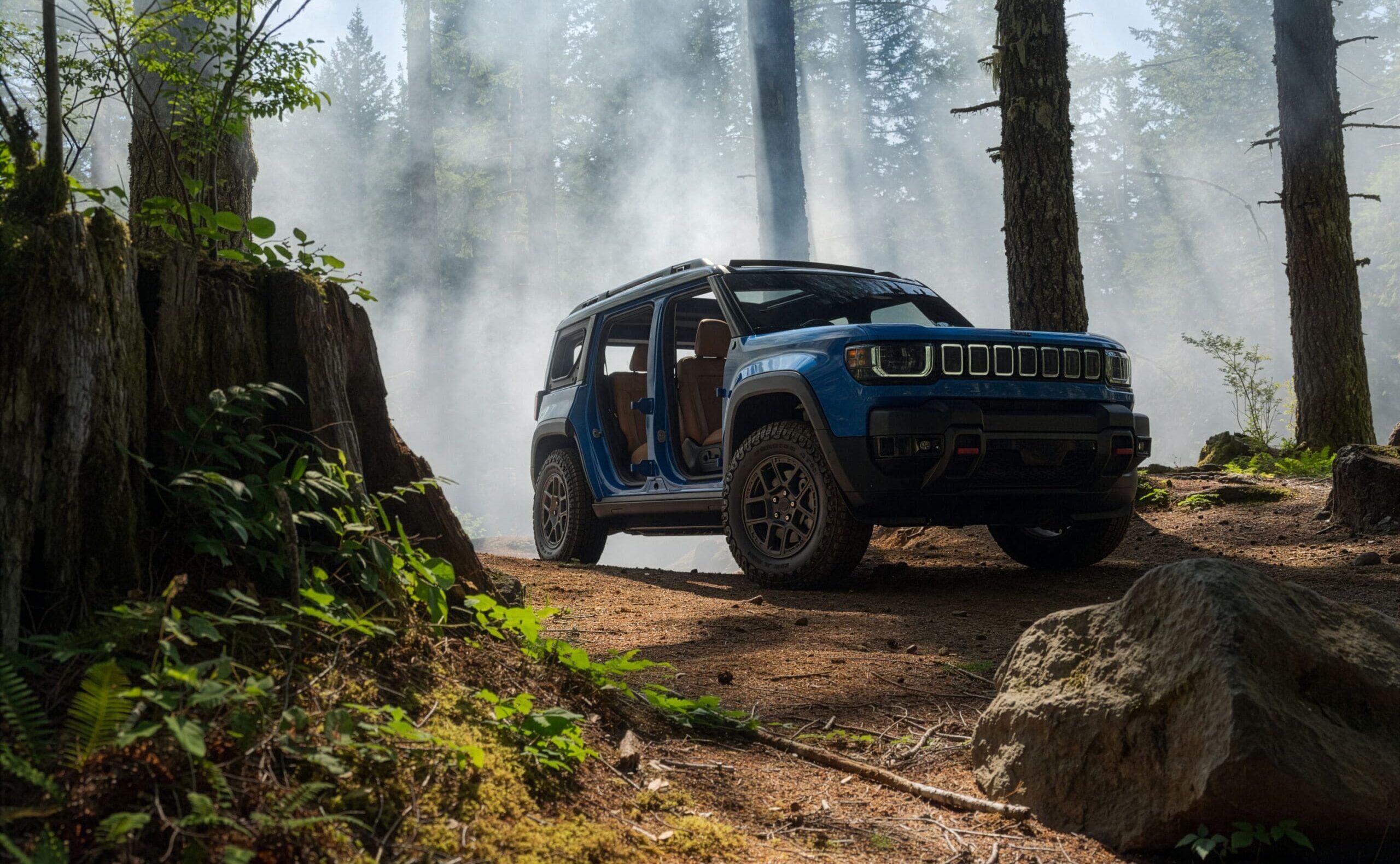 A blue Jeep Recon SUV with open doors is parked on a dirt path in a forest, surrounded by tall trees and mist.