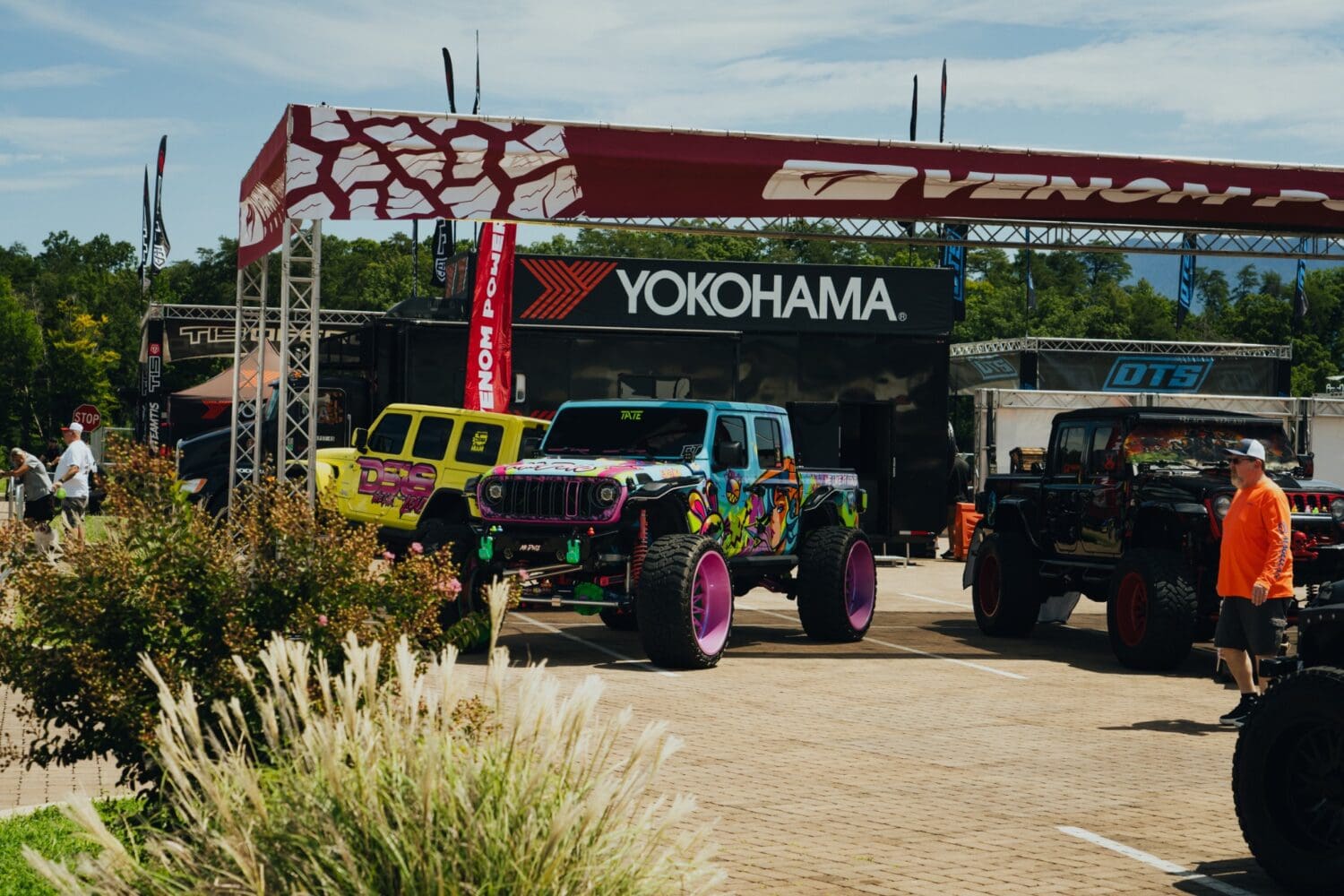Colorful custom Jeeps gathered near the Yokohama booth