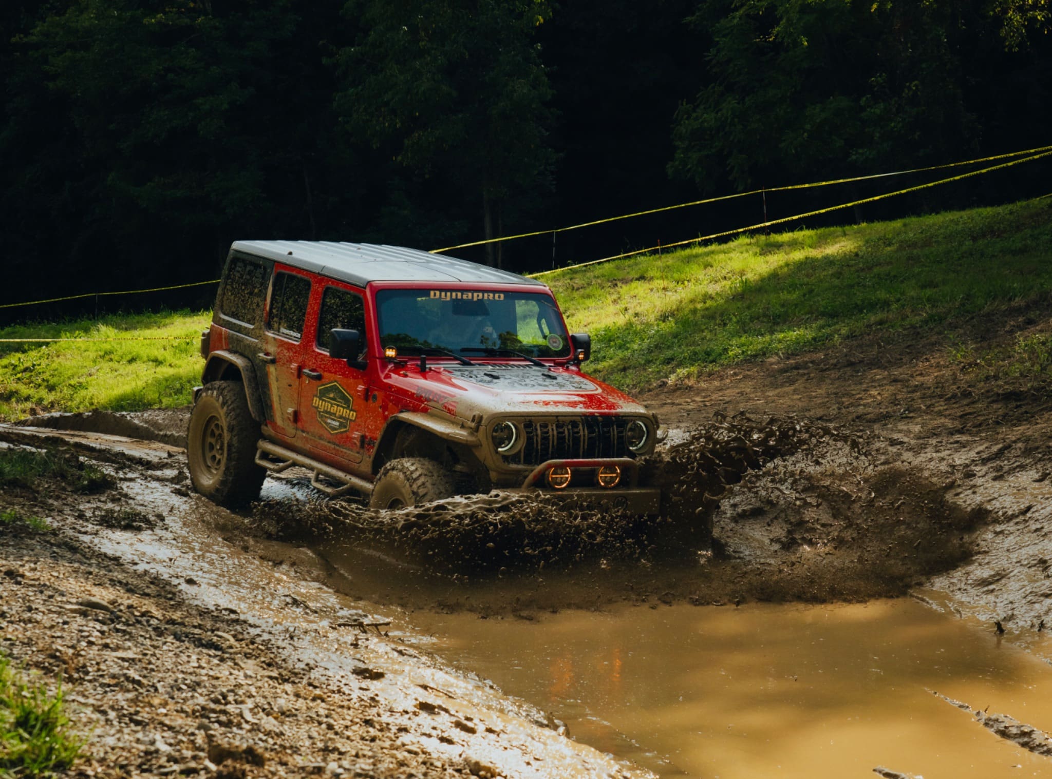Hankook Dynapro Jeep powering through a muddy trail at Smoky Mountain Jeep Invasion