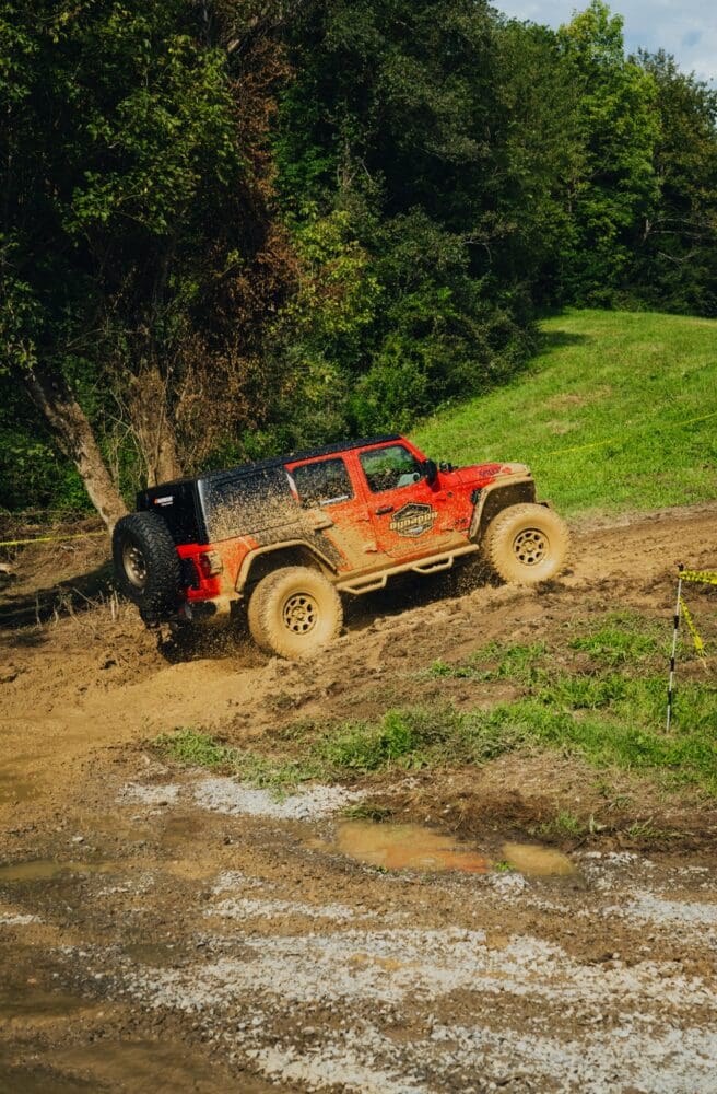 A Hankook Dynapro Jeep climbs the muddy Mountain Mile course at Smoky Mountain Jeep Invasion