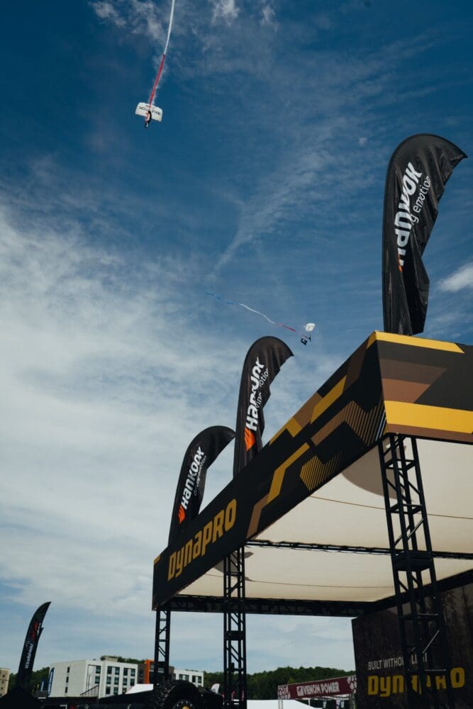 Paratroopers descend above the Hankook Dynapro booth during Jeep Invasion