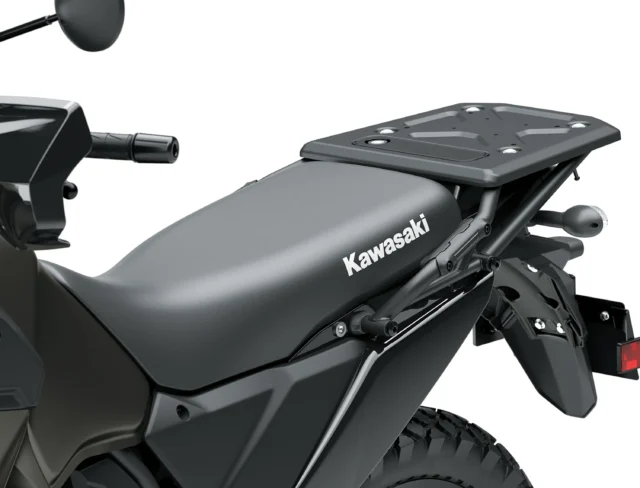 Close-up of a Kawasaki KLR650 motorcycle seat featuring a rear cargo rack.
