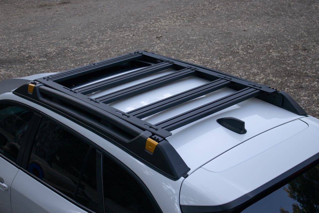 Black Leitner Designs roof rack installed on a white vehicle.
