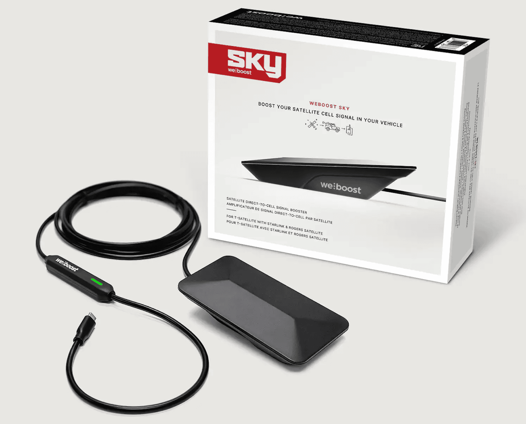 The WeBoost Sky satellite cell signal booster for off-road news is shown with its product packaging, signal booster unit, and power cable.