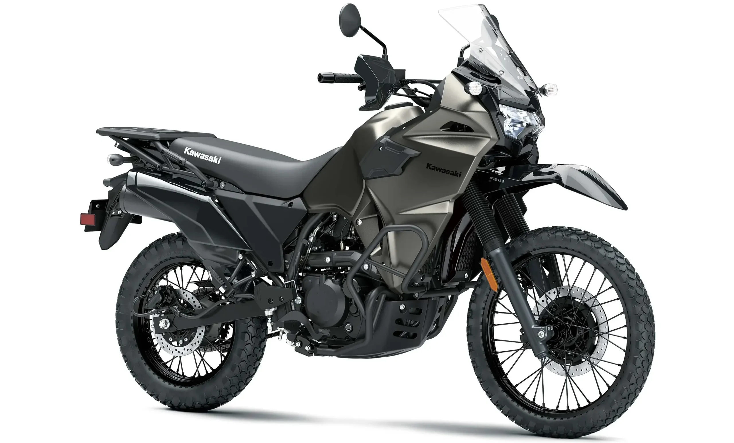 A dark gray 2027 KLR650 adventure motorcycle with a tall windscreen and knobby tires.